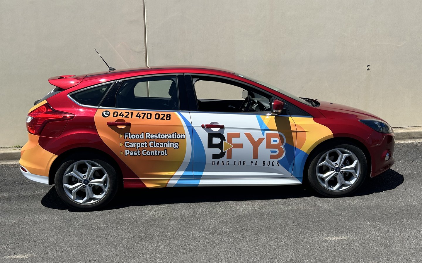 The BFYB wrapped car, showing flood restoration, carpet cleaning and pest control